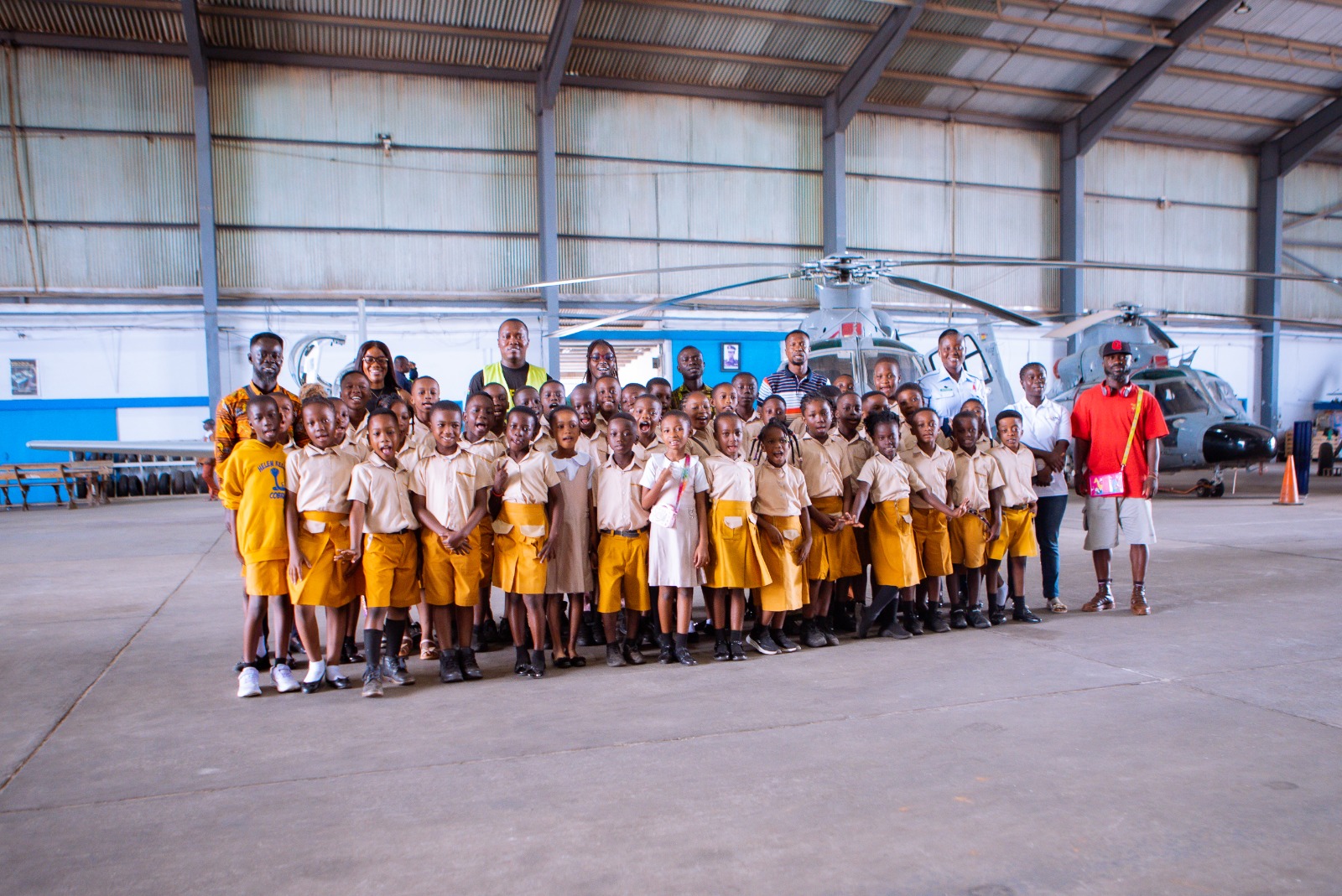 School educational field trip to an aviation hangar with helicopter